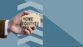 Home equity concept. Hand holds model of home. Royalty Free Stock Photo