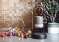 Home espresso machine with coffee cup and capsules on black kitchen background Royalty Free Stock Photo