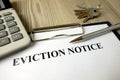 Home eviction notice legal document with pen calculator and keys Royalty Free Stock Photo