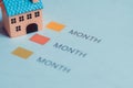 Home Expense Planning Chart with Monthly Payment Indicators and Toy House Royalty Free Stock Photo