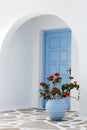 Home exterior with blue door and flowers in Greece Royalty Free Stock Photo