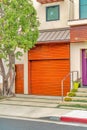 Home exterior with brown garage door and roof overhang in Long Beach California