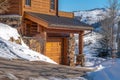 Home exterior in Park City Utah against blue sky and snow dusted hill in winter Royalty Free Stock Photo