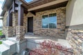 Home facade with porch and gabled portico at the entrance with brown front door Royalty Free Stock Photo