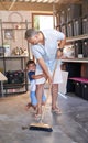 Home, family and kid cleaning or sweep, garage and broom for dust or dirt remove. Happy, playful son with father for Royalty Free Stock Photo