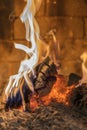 Home fireplace with beautiful orange fire and wood fire close. Burning fire in the fireplace. Logs on fire. vertical photo