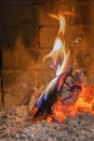 Home fireplace with beautiful orange fire and wood fire close. Burning fire in the fireplace. Logs on fire. vertical photo