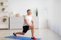 Home fitness. Motivated mature man doing lunges in living room interior, free space, banner design