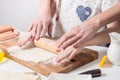 Home Food: Mom and daughter roll out dough. Royalty Free Stock Photo