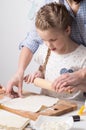 Home Food: Mom and daughter roll out dough. Royalty Free Stock Photo