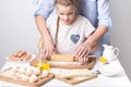 Home Food: Mom and daughter roll out dough. Royalty Free Stock Photo