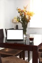 Home freelance desktop with open laptop computer, cup of coffee, business person net-book with blank screen for