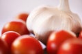 Home, garlic and tomatoes with kitchen counter, ingredients and groceries with recipe and healthy. Wellness, closeup and Royalty Free Stock Photo