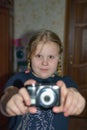 At home, the girl learns to take pictures. Royalty Free Stock Photo
