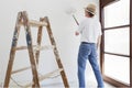 Home handyman or professional painter painting a room in his house