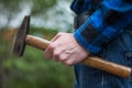 Home handyman: Rear view of a young man with hammer in his hand