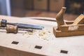 Home handyman using a plane for smoothing down a piece of timber