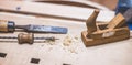 Home handyman using a plane for smoothing down a piece of timber