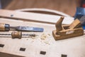 Home handyman using a plane for smoothing down a piece of timber