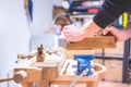 Home handyman using a plane for smoothing down a piece of timber