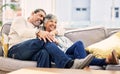 Home, happy and senior couple on a couch, love or relax with happiness, marriage or watching tv. Romantic, old woman or Royalty Free Stock Photo