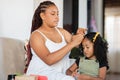 Home Harmony. Mom combs her daughter's hair
