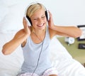 Home, headphones and woman with music, smile and streaming sound with radio, peace and bed. Zen person, technology or