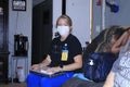 A Home Health care worker with a white wall in the background