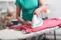 Home helper ironing clothes for an old woman Royalty Free Stock Photo