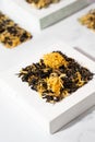 Home herbal tea with calendula flowers On a white podium. Plaster pedestal. Calming drinks concept