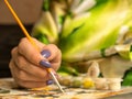 Home hobby in quarantine. Watercolor painting at home. Close-up of a female hand paints a colorful picture with a brush at home. S Royalty Free Stock Photo