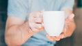 Home hospitality hot drink man offering tea mug Royalty Free Stock Photo