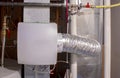 A home humidifier attached to the return duct with a bypass connection to the supply hot air duct Royalty Free Stock Photo