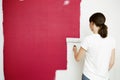 Home improvement. Beautiful woman painting wall with paint roller. Royalty Free Stock Photo