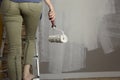 Home improvement. Beautiful woman painting wall with paint rolle Royalty Free Stock Photo