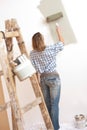 Home improvement: Blond woman painting wall Royalty Free Stock Photo