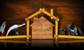 Home Improvement Concept - Wooden Model House and Work Tools Royalty Free Stock Photo