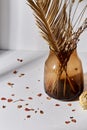 Decorative dried flowers in glass vase and petals