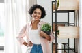 woman decorating home with flower or houseplant Royalty Free Stock Photo