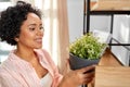 woman decorating home with flower or houseplant Royalty Free Stock Photo