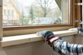 Home improvement handyman installing window sill in new build attic by using leveler and laser leveler Royalty Free Stock Photo