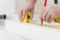 Home improvement - handyman measure porous brick Royalty Free Stock Photo