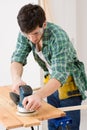 Home improvement - handyman sanding wooden floor Royalty Free Stock Photo