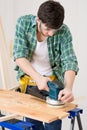 Home improvement - handyman sanding wooden floor Royalty Free Stock Photo
