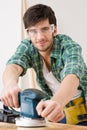 Home improvement - handyman sanding wooden floor Royalty Free Stock Photo