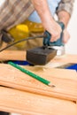 Home improvement - handyman sanding wooden floor Royalty Free Stock Photo