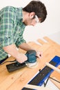 Home improvement - handyman sanding wooden floor Royalty Free Stock Photo