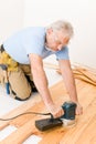 Home improvement - handyman sanding wooden floor Royalty Free Stock Photo