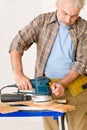 Home improvement - handyman sanding wooden floor Royalty Free Stock Photo