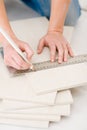 Home improvement - handywoman measuring tile Royalty Free Stock Photo